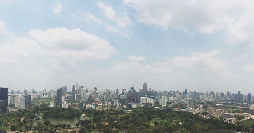 Cityscape against cloudy sky