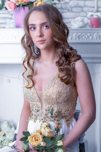 Portrait of beautiful young woman with bouquet