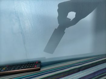 Close-up of open book on table against wall