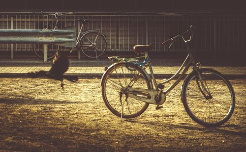 Bicycle parked against brick wall