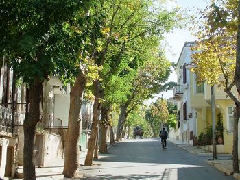 Rear view of man walking on street in city