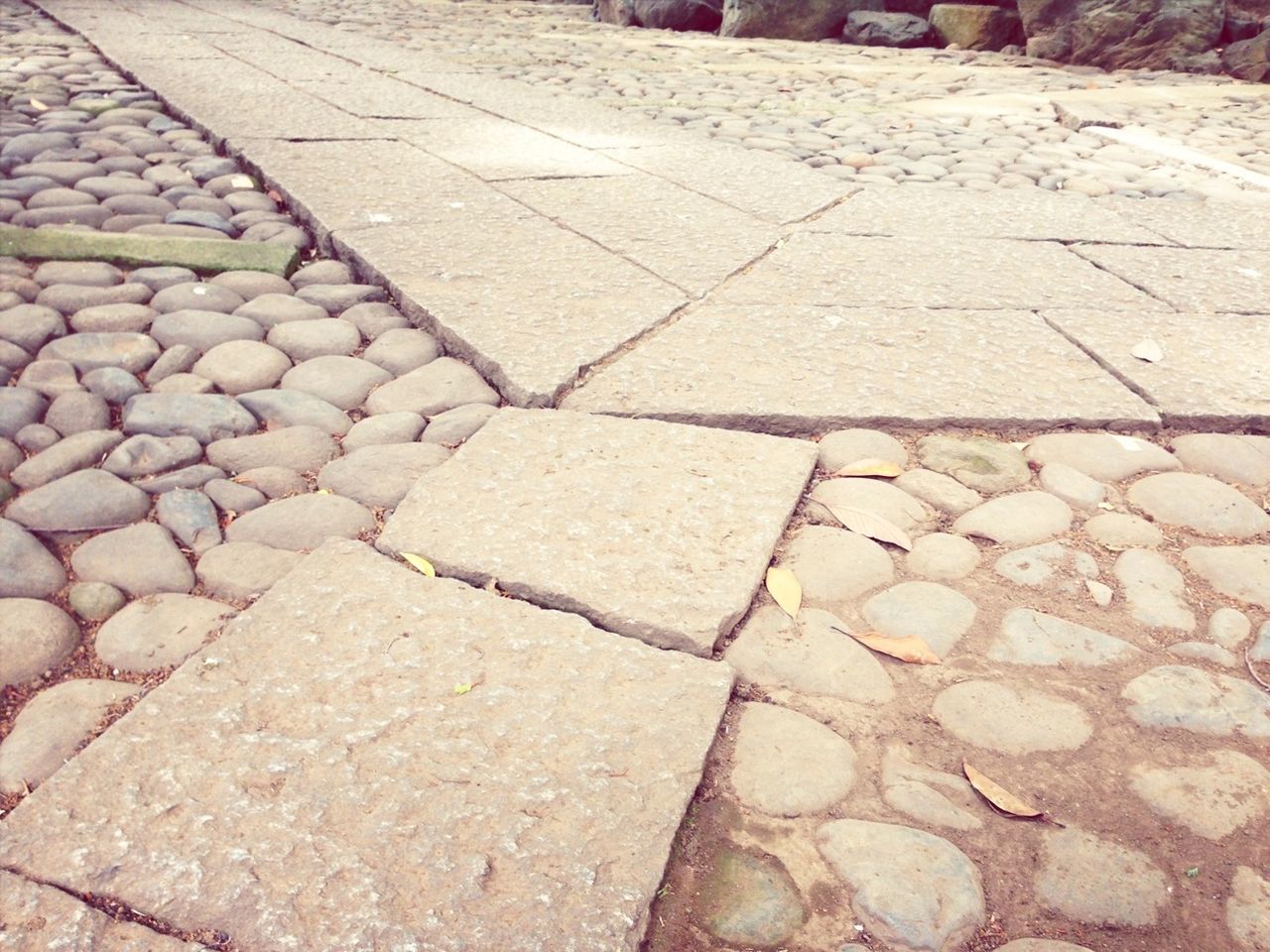 cobblestone, pattern, paving stone, textured, full frame, backgrounds, high angle view, footpath, street, stone - object, sunlight, no people, day, stone material, outdoors, abundance, repetition, stone wall, pavement, stone