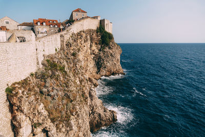 Panoramic view of sea and buildings against sky