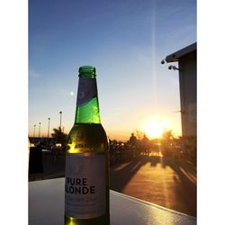 Close-up of beer bottles against clear sky