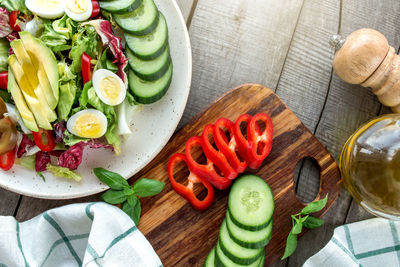 Mediterranean diet concept flat lay. plate with salad, quail egg, vegetables on wooden background