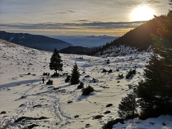 Scenic view of snowcapped mountains against sky during sunset