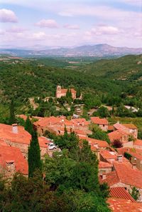 High angle view of trees and buildings against sky