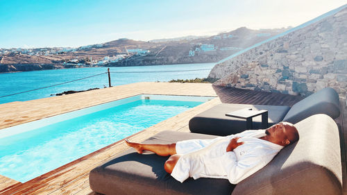 Pool side relaxation with sea view. 