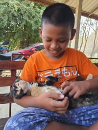 A boy playing with cat