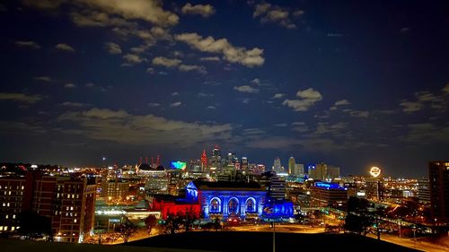 High angle view of city lit up at night