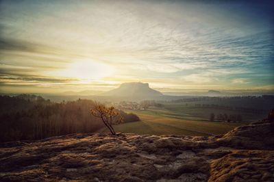 Scenic view of field against sky during sunset