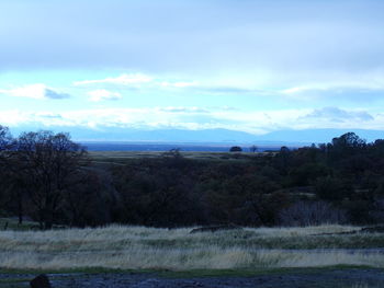 Scenic view of landscape against cloudy sky