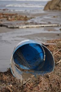 Close-up of blue ball on beach