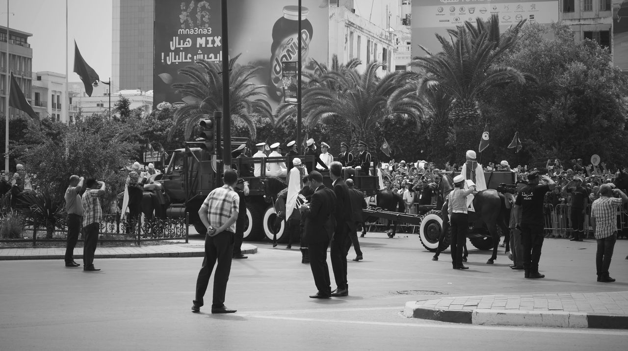 group of people, large group of people, real people, crowd, city, architecture, tree, building exterior, built structure, plant, men, street, women, day, lifestyles, leisure activity, palm tree, adult, walking