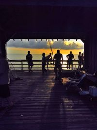 People on beach at sunset