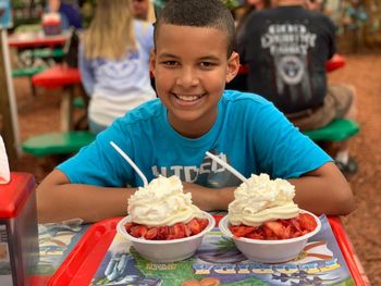 Portrait of smiling boy having dessert at restaurant