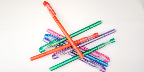 High angle view of colored pencils against white background