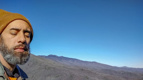 Portrait of man against blue sky