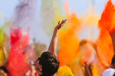 Group of woman with arms raised at music concert