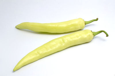 Close-up of green chili pepper against white background