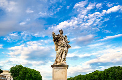 Low angle view of statue against cloudy sky