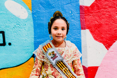 Portrait of smiling boy against wall