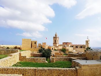 View of old buildings against sky