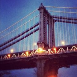 Low angle view of suspension bridge at night