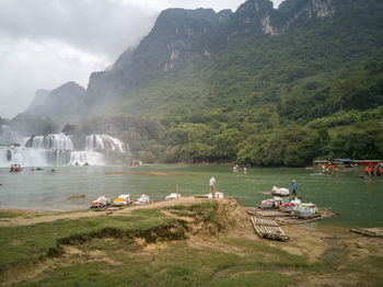 Scenic view of sea and mountains against sky