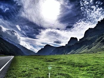 Scenic view of landscape against cloudy sky