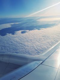 Aerial view of cloudscape over airplane wing