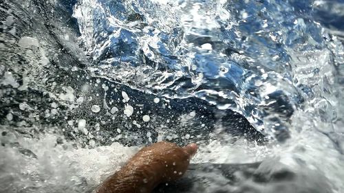 Close-up of person splashing water