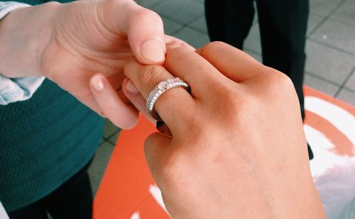 Cropped image of couple holding hands