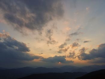 Scenic view of silhouette mountains against sky at sunset