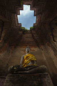 Low angle view of statue against historic building