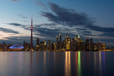 Scenic view of lake ontario in illuminated city against sky