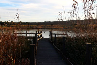 Pier over lake against sky