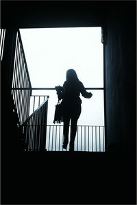 Full length of woman standing on wall