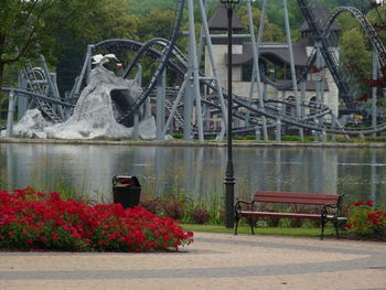 View of park bench by lake