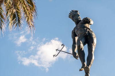 Low angle view of statue against blue sky