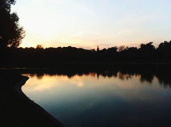 Scenic view of calm lake at sunset