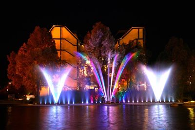 Reflection of illuminated lights in puddle