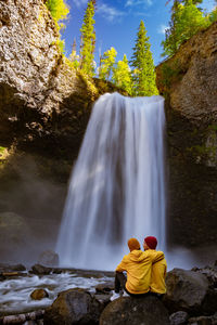 Rear view of waterfall against rocks