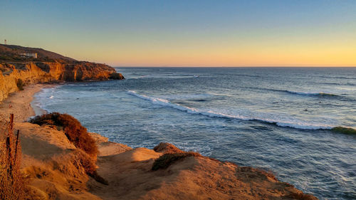 Scenic view of sea against clear sky during sunset