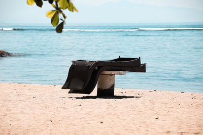 Lifeguard hut on beach against sky