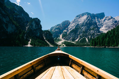 Scenic view of lake by mountains against sky