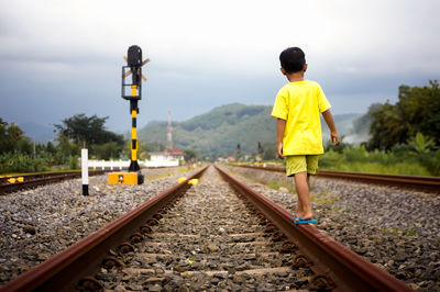A boy walk in railroad in kebasen trainstation indonesia