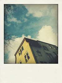 Low angle view of built structure against cloudy sky