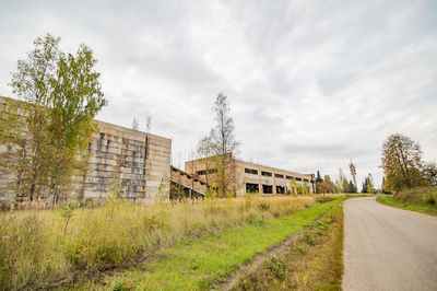 Road amidst buildings against sky