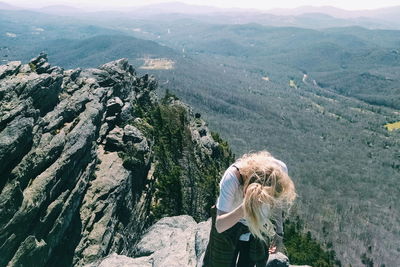 High angle view of woman standing on mountain against landscape